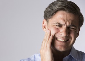 Studio Portrait Of Man Suffering With Toothache